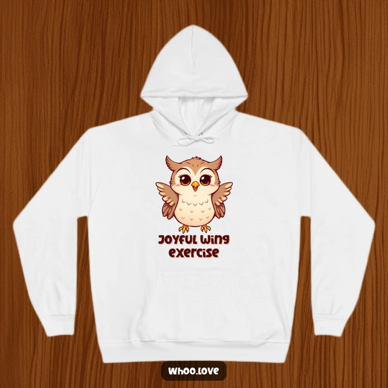 Funny hoodie depicting a little owl enthusiastically flapping tiny wings, looking surprised and happy, embodying pure delight.